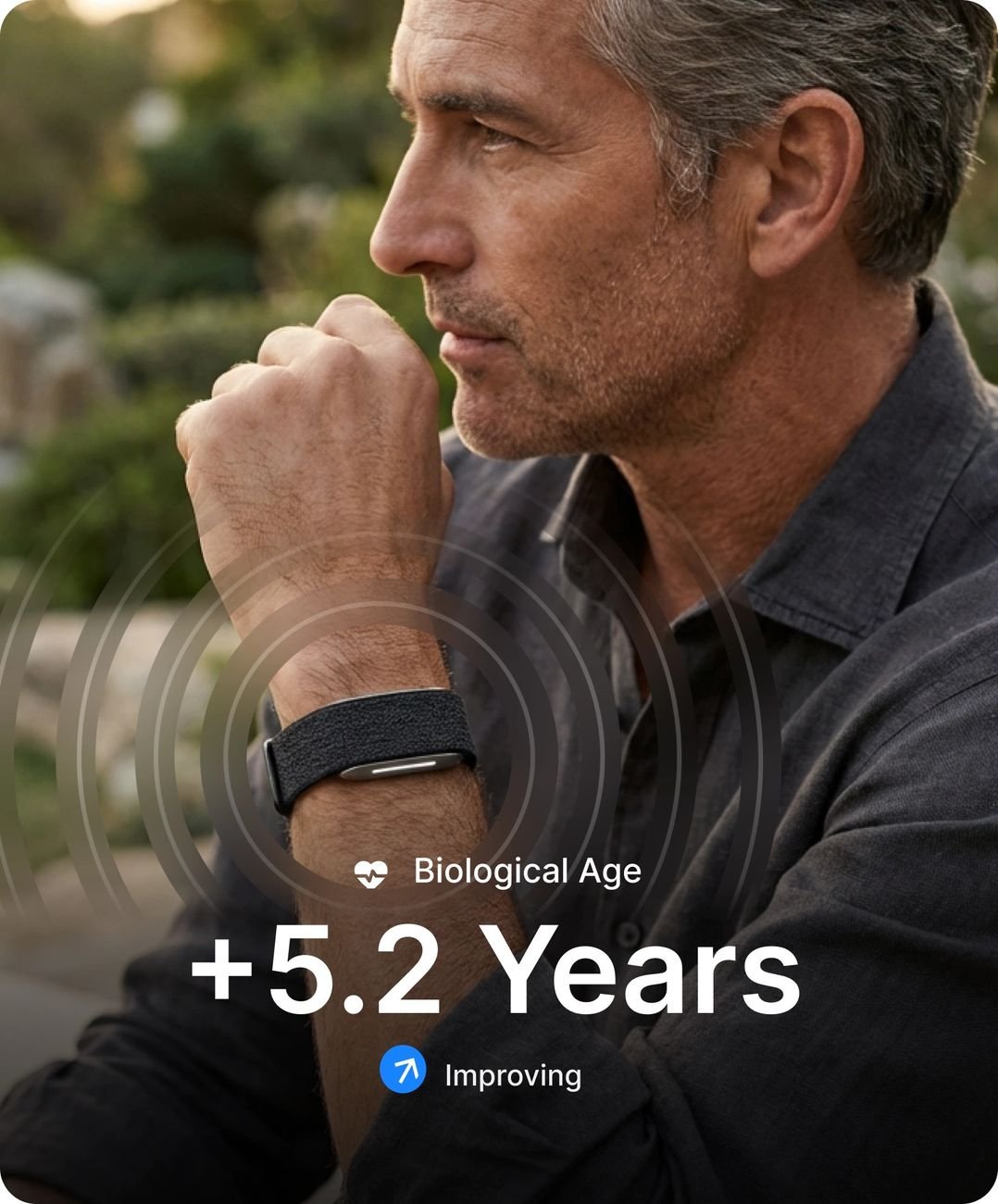 Man wearing the Human Band with biological age and chronic illness risk shown in app